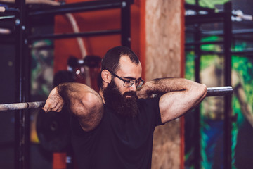 Fototapeta na wymiar Young man doing weight lifting in gym