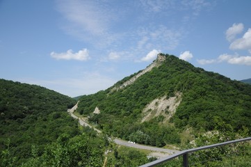 View from the observation deck of the mountains, the forested valley and the mountain road