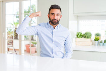 Fototapeta premium Handsome hispanic business man Strong person showing arm muscle, confident and proud of power