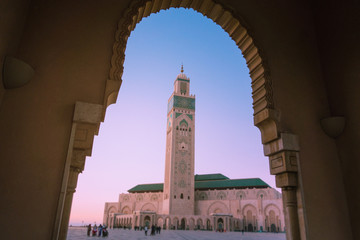 view of Hassan II mosque framed by the arch of a big gate