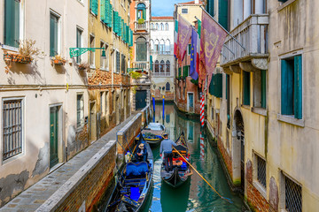 Narrow canal with gondola and bridge in Venice, Italy. Architecture and landmark of Venice. Cozy...