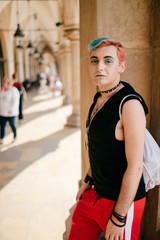 Homosexual man with make up  and colorful hairstyle lifestyle portrait on street