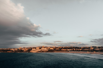 The first rays of morning sun hit the South Bondi Headland on a cold winter morning.