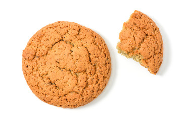 Homemade cookies. Whole and piece sweet cookie with crumbs made from oatmeal flour. Tasty biscuit in high resolution closeup, isolated on white background top view with shadows. Homemade bakery.