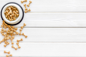 Puppy dry food on white wooden background top view mock up