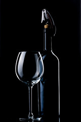 A bottle of wine. Wine glass. Natural cork. Metal corkscrew.