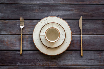 Elegant table setting with plates and tableware on wooden background top view