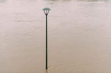 Flood in the city effects. High level of water in the river after hard rain.