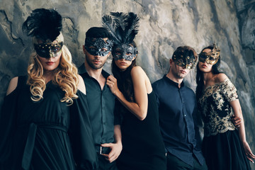 Group of people in masquerade carnival mask posing in studio - obrazy, fototapety, plakaty