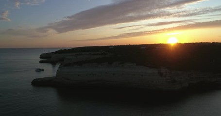 Sunset aerial view on Praia da Senhora da Rocha in the south coast of Algarve destination region, Portugal.