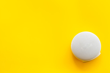 Audio listening with wireless speaker on yellow background top view space for text