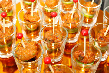 fried fish-paste balls in small glass on buffet line
