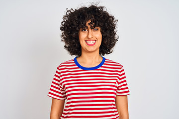 Young arab woman with curly hair wearing striped t-shirt over isolated white background with a happy and cool smile on face. Lucky person.