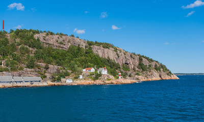 Fototapeta na wymiar Beautiful seascape norwegian coastline, coast of Kristiansand with small lighthouse, Scandinavia, Norway. July 2019
