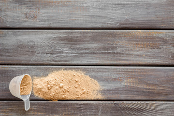 Nutrition for workout with protein cocktail powder on wooden background top view mockup