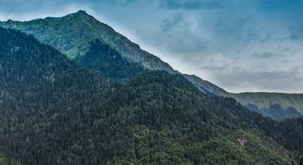 Fototapeta premium Natural landscape with mountains and forests against the sky.