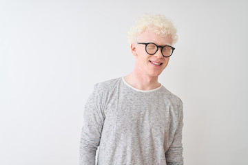 Young albino blond man wearing striped t-shirt and glasses over isolated white background winking...