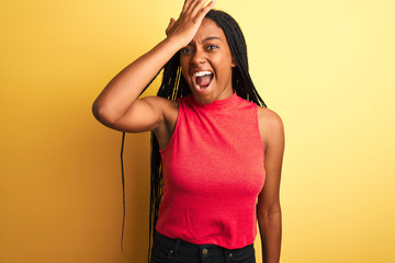 African american woman wearing red casual t-shirt standing over isolated yellow background...