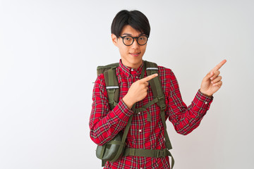 Chinese hiker man wearing backpack canteen glasses over isolated white background smiling and looking at the camera pointing with two hands and fingers to the side.