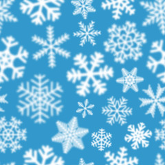 Obraz premium Christmas seamless pattern of white defocused snowflakes on light blue background
