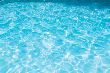 Fototapeta na wymiar Blue and bright sea water surface with sunrefection, Water in swimming pool