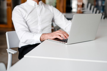 man in white shirt working on laptop in the office