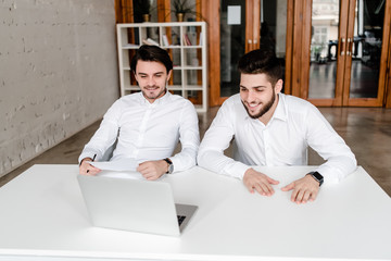 two co workers discuss business in the office