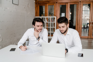 two co workers discuss business in the office