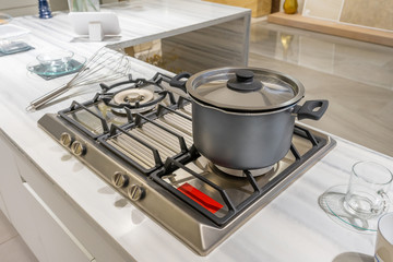 Metal Pot on induction hob in modern kitchen. modern kitchen pot cooking induction electrical stove...
