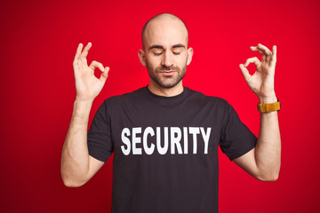 Young safeguard man wearing security uniform over red isolated background relax and smiling with...