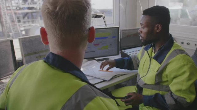 Two technicians working in control room
