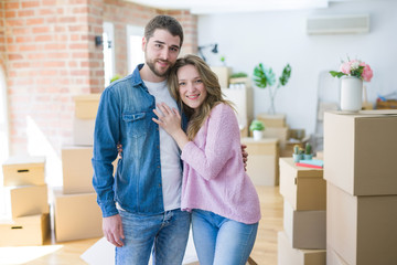 Young beautiful couple looking happy together moving to a new home