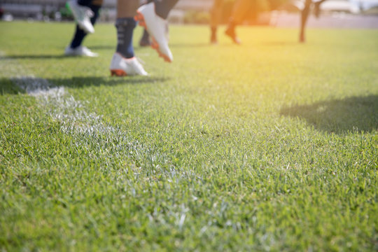 blur football players training warm up on green field