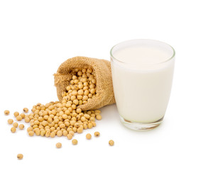 Glass of Soy milk with soybeans in bag isolated on white background.