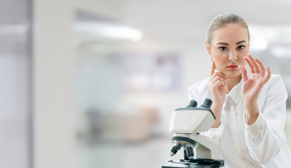 Scientist researcher using microscope in laboratory. Medical healthcare technology and...