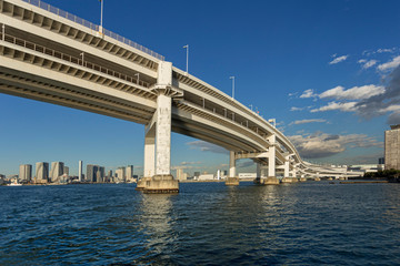 Rainbow bridge and a urban cityscape on the background