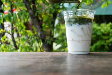 glass of ice green tea with milk