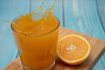 orange juice in glass on wooden table