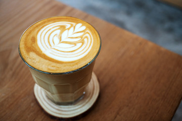 The latte art coffee served within ceramic cup