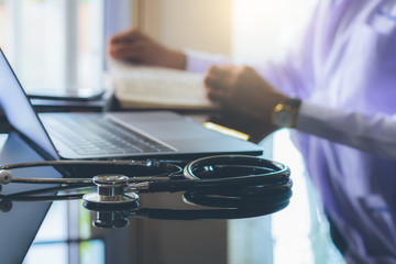 Doctor reading text book. Online medicals learning concept.