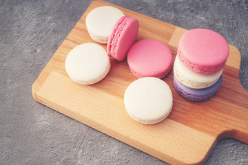 Cake macaron or macaroon on turquoise background from above, colorful almond cookies, pastel colors