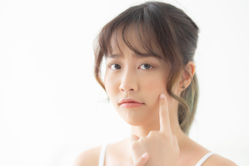 Beautiful portrait young asian woman with acne problem in the bedroom, trouble of beauty on face, zit treatment, asia girl is pimple having worry and displeased, skincare and healthy concept. © NT_studio