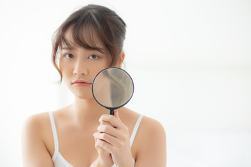 Beautiful young asian woman with magnifying of skin a problem of acne, beauty asia girl check...