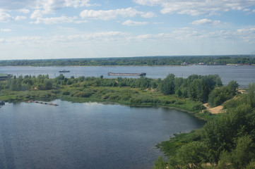 view of the shore of a picturesque river and clouds in the sky