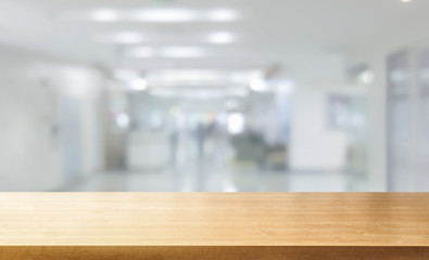 Wood table in modern hospital interior with empty copy space on the table for product display...