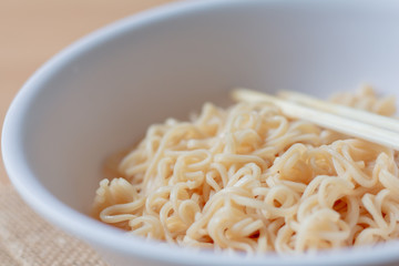close up eating instant noodle in white bowl.