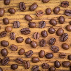 Coffee bean. The background of roasted coffee beans is brown on wooden boards. layout. Flat lay.