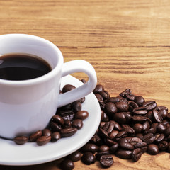 A cup of coffee and scattered coffee beans. Layout. Flat lay. Coffee bean.