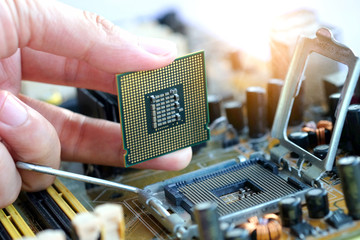 Hand of computer engineering brings computer cpu processor memory change components into socket processor for maintenance.Technology and development concept
