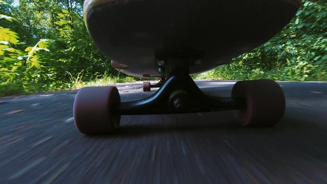 male person with white high socks longboarding